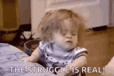 A Little Girl Is Sitting On A Bed With Her Eyes Closed And The Words `` The Struggle Is Real '' . GIF