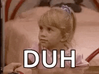 A Little Girl Is Sitting On A Bed With The Words `` Duh '' Written On It . GIF