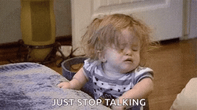 A Little Girl Is Sitting On A Couch And Making A Funny Face While Talking . GIF