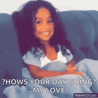 A Little Girl Is Sitting On A Couch And Smiling With The Words `` Hows Your Day Going ? My Love '' . GIF