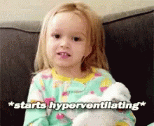 A Little Girl Is Sitting On A Couch Holding A Stuffed Animal And Saying " Starts Hyperventilating " . GIF