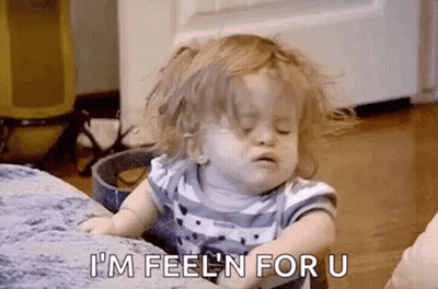 A Little Girl Is Sitting On A Couch With Her Eyes Closed And Making A Face . GIF