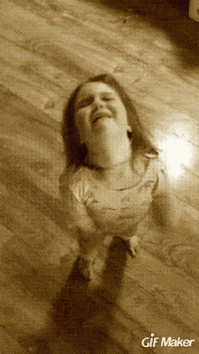 A Little Girl Is Sitting On A Wooden Floor With A Gif Maker Watermark GIF