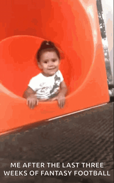 A Little Girl Is Sitting On An Orange Slide With The Caption Me After The Last Three Weeks Of Fantasy Football GIF