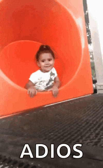 A Little Girl Is Sliding Down An Orange Slide With The Words Adios Written On The Bottom GIF