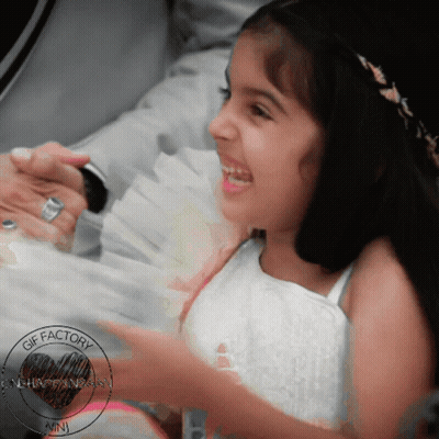 A Little Girl Is Smiling In A Photo That Was Taken By The Gif Factory GIF