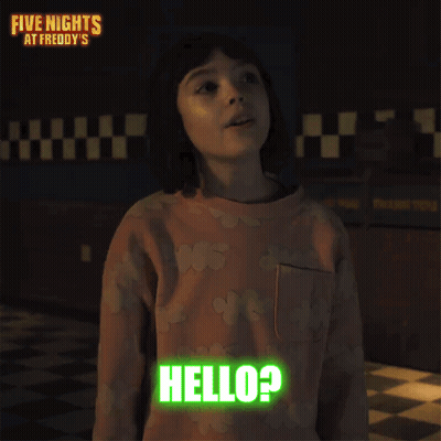 A Little Girl Is Standing In A Dark Room And Says Hello ? GIF