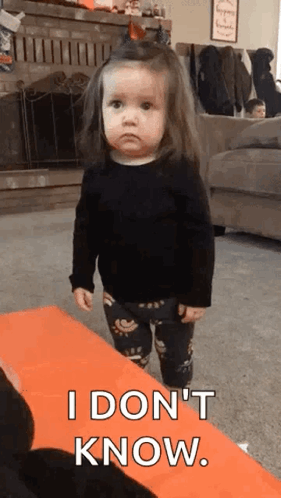 A Little Girl Is Standing In A Living Room And Saying `` I Don 'T Know . '' GIF
