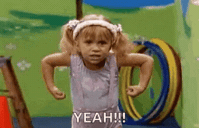 A Little Girl Is Standing In A Playground With Her Hands On Her Hips And Saying `` Yeah '' . GIF