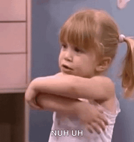 A Little Girl Is Standing In A Room With Her Arms Outstretched And A Ponytail . GIF