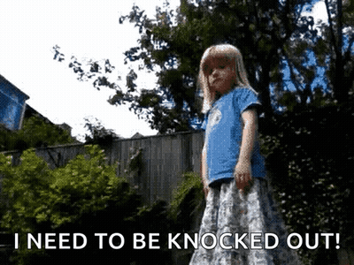 A Little Girl Is Standing In Front Of A Fence With The Words I Need To Be Knocked Out Below Her GIF