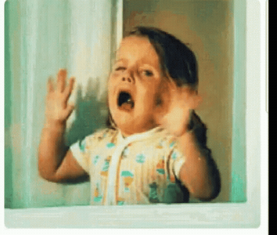 A Little Girl Is Standing In Front Of A Window With Her Mouth Open . GIF