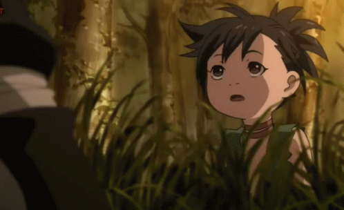 A Little Girl Is Standing In The Grass And Looking At Something GIF