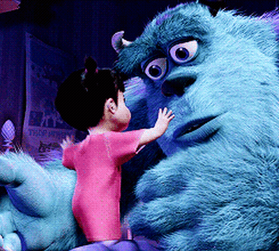 A Little Girl Is Standing Next To A Monster From Monsters Inc. GIF