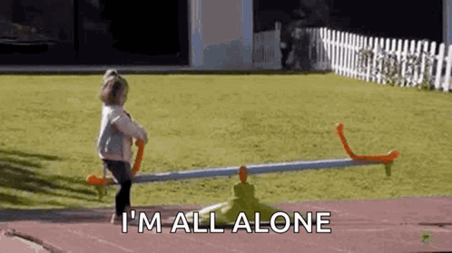 A Little Girl Is Standing On A Seesaw In A Yard . GIF