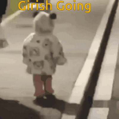 A Little Girl Is Walking Down A Sidewalk With The Words " Girish Going " On The Bottom GIF