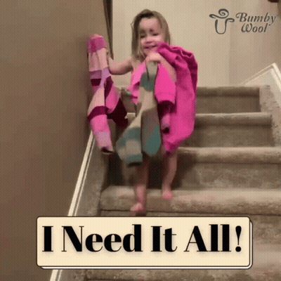 A Little Girl Is Walking Up A Set Of Stairs With A Sign That Says I Need It All .. GIF