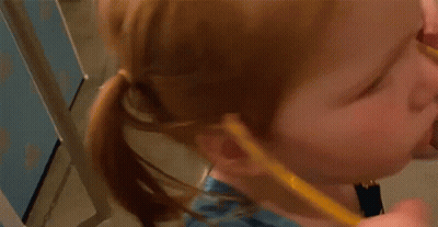 A Little Girl Is Wearing A Blue Dress And Holding A Yellow Pencil . GIF