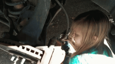 A Little Girl Is Working On A Car And Has A Dirty Face GIF