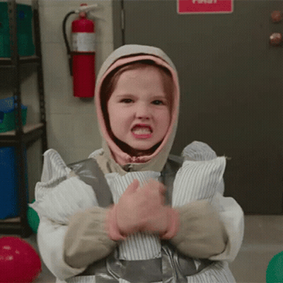 A Little Girl Is Wrapped In Duct Tape And Has A Hood On Her Head GIF