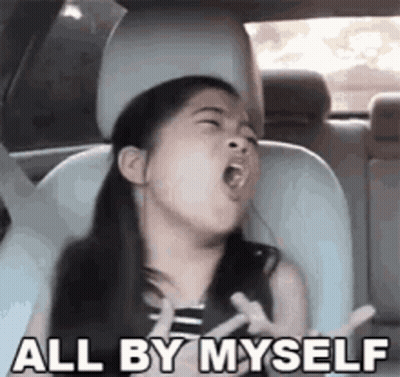 A Little Girl Is Yawning In A Car Seat And Making A Funny Face . GIF