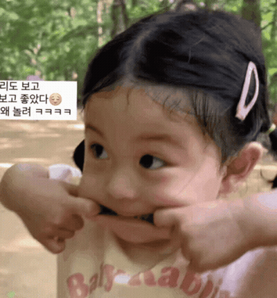 A Little Girl Making A Funny Face Wearing A Shirt That Says Baby Rabbit GIF