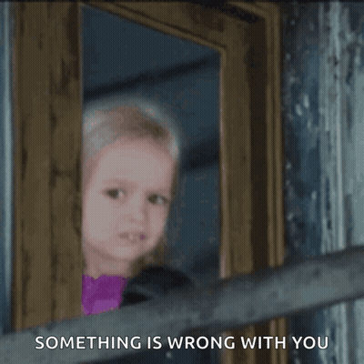 A Little Girl Peeking Out Of A Door With The Words Something Is Wrong With You Written Below Her GIF