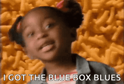 A Little Girl Says I Got The Blue Box Blues In Front Of A Pile Of Macaroni Cheese GIF