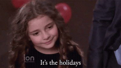 A Little Girl Says It 'S The Holidays In Front Of A Balloon GIF