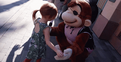 A Little Girl Shakes Hands With A Stuffed Monkey Wearing A Pirate Outfit GIF