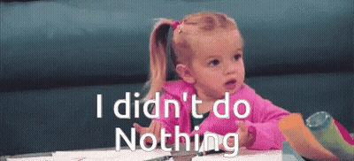 A Little Girl Sitting At A Table With The Words " I Did N't Do Nothing " On The Bottom GIF