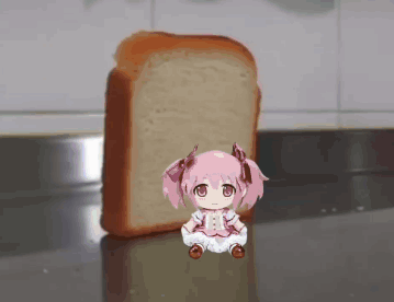 A Little Girl Sitting Next To A Loaf Of Bread GIF