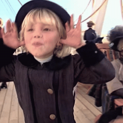 A Little Girl Wearing A Black Hat And A Black Coat GIF