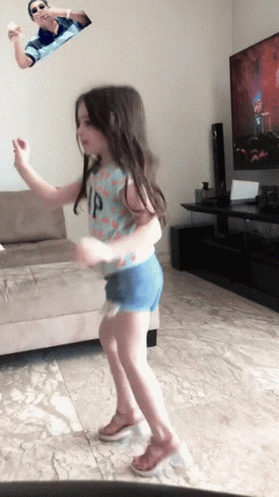 A Little Girl Wearing A Gap Shirt Is Dancing GIF