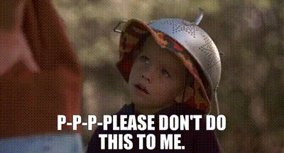 a little girl wearing a hat and a strainer on her head is talking to someone .
