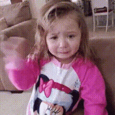 A Little Girl Wearing A Pink Minnie Mouse Shirt GIF