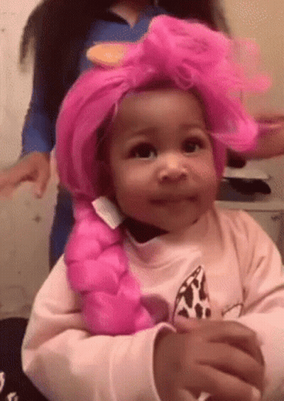 A Little Girl Wearing A Pink Wig And A Pink Braid . GIF