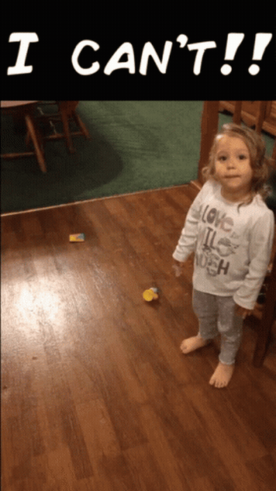 A Little Girl Wearing A Shirt That Says I Love It Enough Is Standing On A Wooden Floor GIF