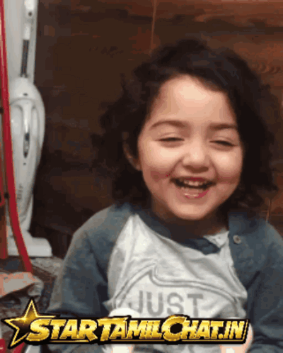 A Little Girl Wearing A Shirt That Says Just Is Smiling GIF