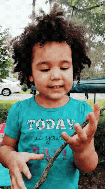 A Little Girl Wearing A Shirt That Says Today Is Your Day Is Holding A Stick GIF
