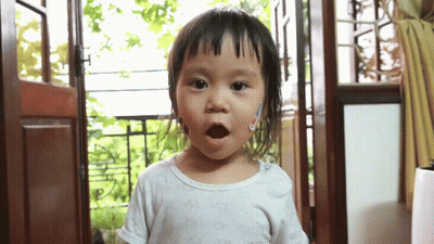 A Little Girl Wearing A White Shirt That Says ' Gucci ' On It GIF