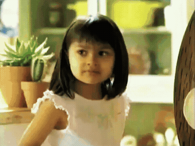 A Little Girl Wearing A White Shirt That Says " I Love You " On It GIF