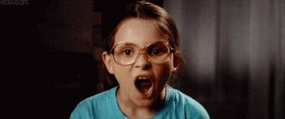A Little Girl Wearing Glasses Is Making An Angry Face . GIF