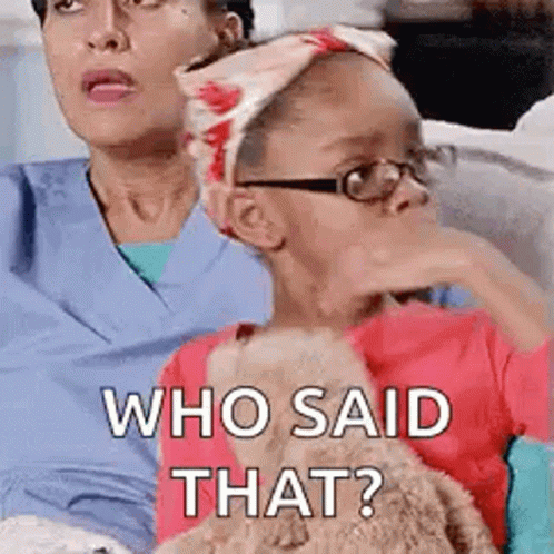 A Little Girl Wearing Glasses Is Sitting Next To A Woman Wearing Scrubs And A Headband . GIF