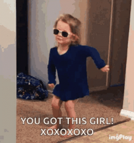A Little Girl Wearing Sunglasses And A Blue Dress Is Dancing In A Room . GIF
