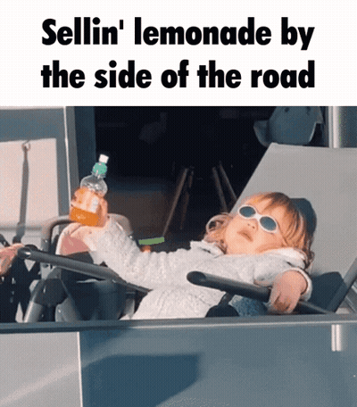 A Little Girl Wearing Sunglasses Is Sitting On A Chair Holding A Bottle Of Lemonade GIF
