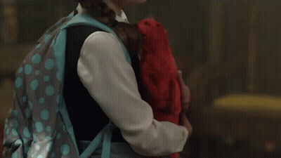 A Little Girl With A Backpack Is Holding A Stuffed Animal GIF