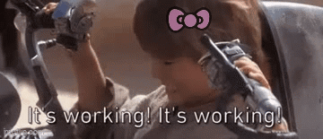 A Little Girl With A Hello Kitty Bow On Her Head Is Sitting In A Chair . GIF