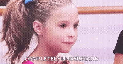 A Little Girl With A Ponytail Is Looking At The Camera With The Words `` Completely Understand '' On Her Face . GIF