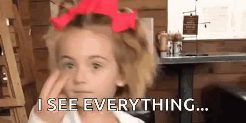 A Little Girl With A Red Bow In Her Hair Is Making A Face And Says `` I See Everything ... '' GIF